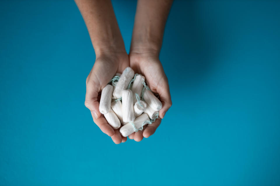 woman holding a whole bunch of tampons