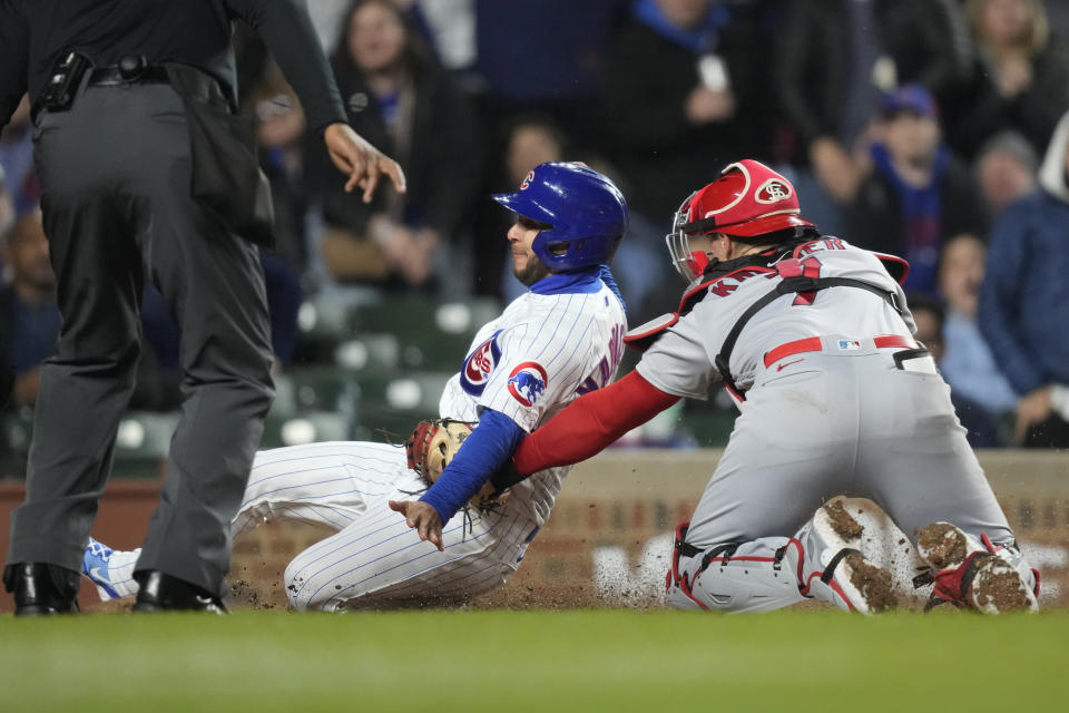 St. Louis Cardinals catcher Andrew Knizner tags out Chicago Cubs pinch-runner Nick Madrigal at home during the fifth inning of a baseball game on Monday, May 8, 2023, in Chicago. (AP Photo/Charles Rex Arbogast)