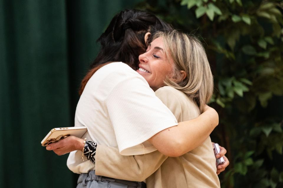 Sister Elaine Finholdt Parrella hugs a young single adult woman at the media open house for the Orem Utah Temple in 2023.