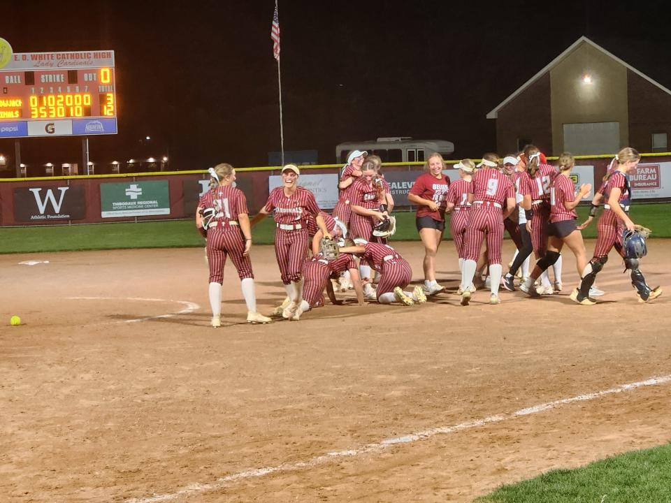 E.D. White softball dogpiles after winning the LHSAA Division II select quarterfinal on Thursday night.