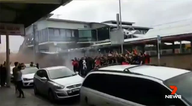 Fans even let off flares at nearby Lidcombe station. Source: 7 News