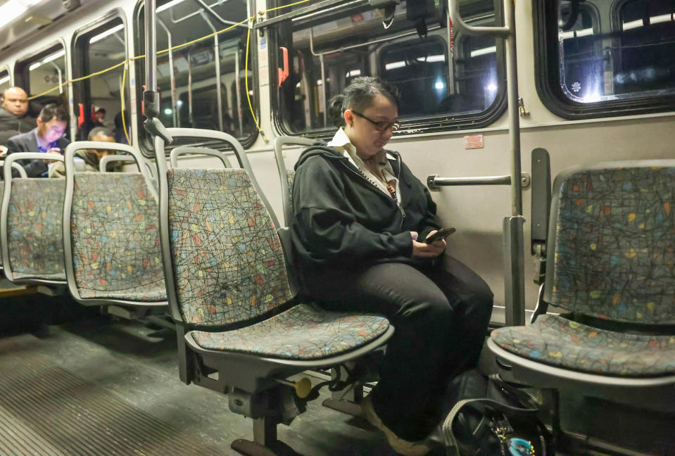 Marshall Shane often listens to music or scrolls on the phone during the early morning bus ride from the southside toward Savannah Arts Academy.