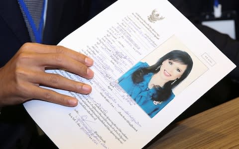 Thai Raksa Chart party leader Preechapol Pongpanich, holds up application of candidate for Prime Minister, Thailand's Princess Ubolratana Rajakanya Sirivadhana Barnavadi, at the election commission office in Bangkok - Credit: Reuters