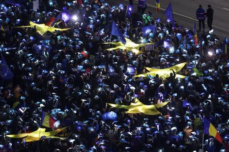 Romanians light up blue pieces of paper and pieces of yellow star shaped fabric thus forming the European Union flag during a protest against the government, in Bucharest, Romania, February 26, 2017. Inquam Photos/Octav Ganea/via REUTERS