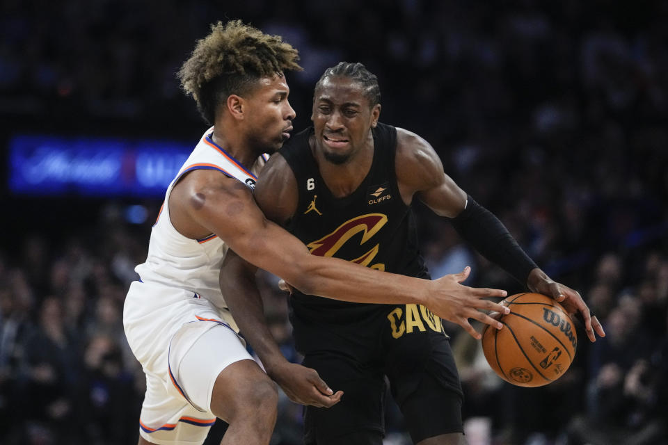 New York Knicks' Miles McBride, left, defends Cleveland Cavaliers' Caris LeVert, right, during the first half of an NBA basketball game Tuesday, Jan. 24, 2023, in New York. (AP Photo/Frank Franklin II)