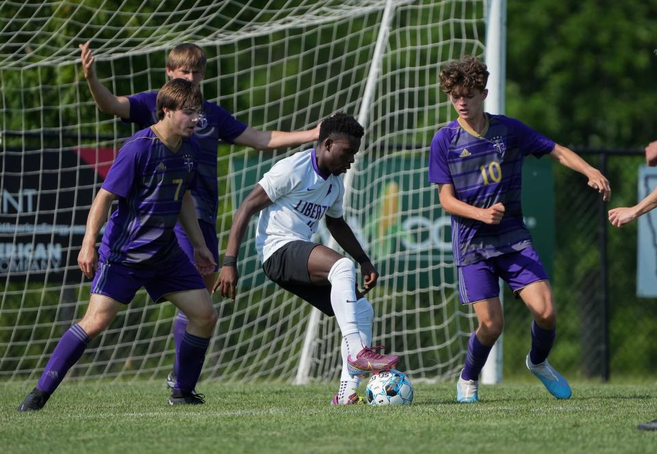 Iowa City Liberty's Flori Gembo moves the ball between Norwalk defenders during the Class 3A boys state soccer finals on Saturday, June 3, 2023, at the James Cownie Soccer Complex in Des Moines.