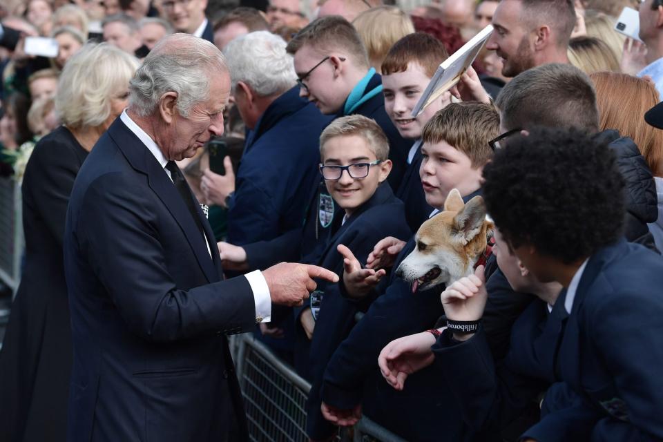 HILLSBOROUGH, NORTHERN IRELAND - SEPTEMBER 13: His Majesty King Charles III accompanied by the Queen Consort is greeted by members of the public including a woman with her pet corgi called Connie outside Hillsborough Castle on September 13, 2022 in Hillsborough, Northern Ireland. King Charles III is visiting Northern Ireland for the first time since ascending to the throne following the death of his mother, Queen Elizabeth II, who died at Balmoral Castle on September 8, 2022. (Photo by Charles McQuillan/Getty Images)