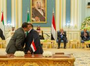 Representatives of Yemen's government and southern separatists embrace each other after signing a Saudi-brokered deal to end a power struggle in the southern port of Aden, in Riyadh