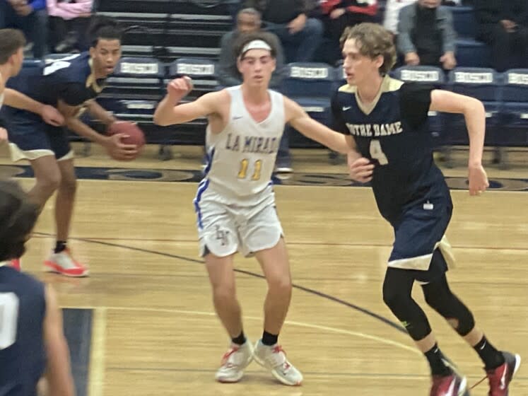 Dusty Stromer (right) of Sherman Oaks Notre Dame is guarded by La Mirada's Julien Gomez.