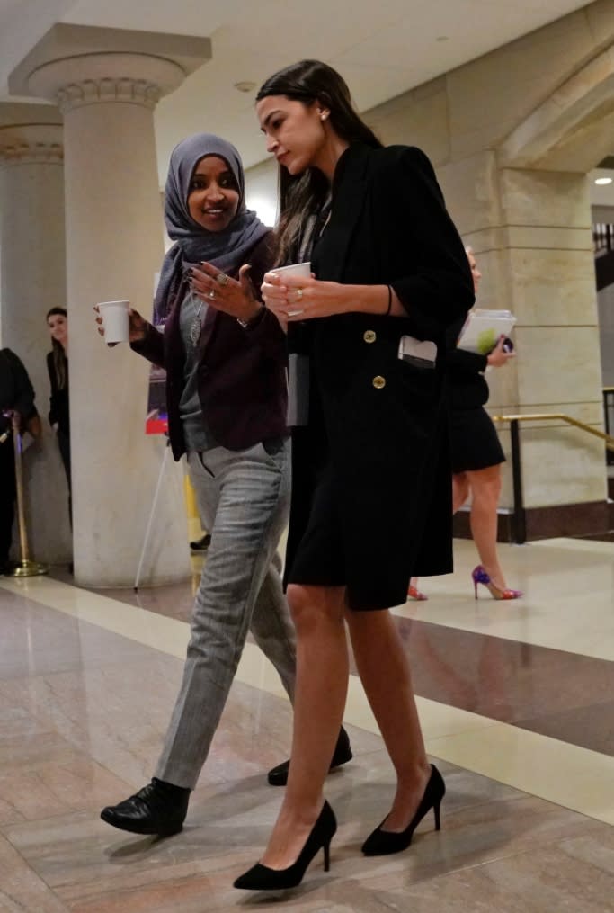 Rep. Alexandria Ocasio-Cortez (R) wearing black heels with Rep. Ilhan Omar on Capitol Hill in Washington. - Credit: Shutterstock