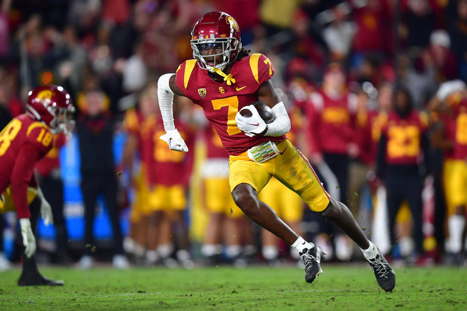 Nov 26, 2022; Los Angeles, California, USA; Southern California Trojans defensive back Calen Bullock (7) runs the ball after an interception against the Notre Dame Fighting Irish during the second half at the Los Angeles Memorial Coliseum. Mandatory Credit: Gary A. Vasquez-USA TODAY Sports