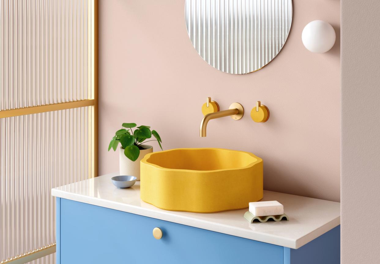  Pink powder room with yellow sink and blue vanity. 