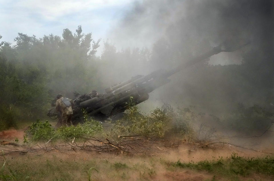 FILE - Ukrainian soldiers fire at Russian positions from a U.S.-supplied M777 howitzer in Ukraine's eastern Donetsk region June 18, 2022. U.S. officials will send another $450 million in military aid to Ukraine. (AP Photo/Efrem Lukatsky, File)