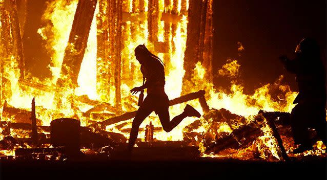 A man runs into the flames at the Burning Man festival burning ceremony. Photo: Reuters