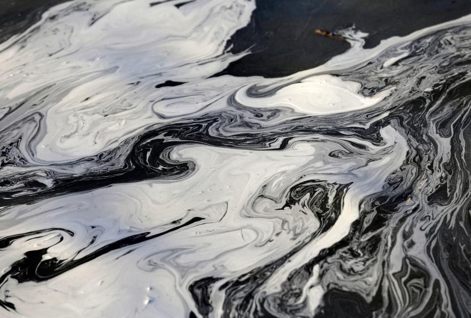 In this Feb. 5, 2014 file photo, coal ash swirls on the surface of the Dan River following one of the worst coal-ash spills in U.S. history.