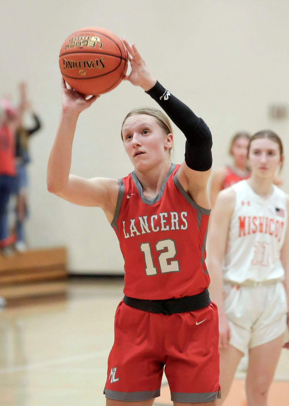 Manitowoc Lutheran’s Marissa Mehlhorn (12) aims a free throw against Mishicot, Thursday, December 7, 2023, in Mishicot, Wis.