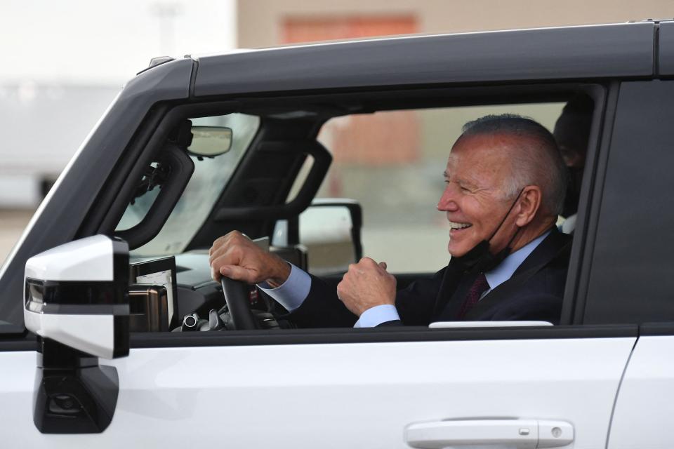President Joe Biden test drives an electric vehicle as he tours an assembly plant in Detroit in 2021.