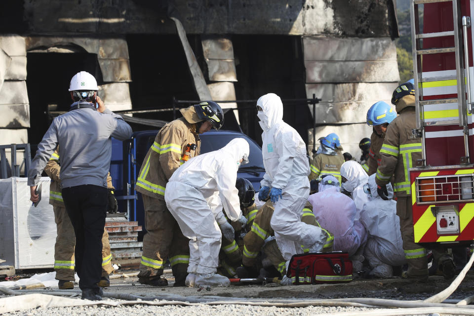 Firefighters prepare to carry an injured worker after a fire engulfed a construction site in Icheon, South Korea, Wednesday, April 29, 2020. Several workers were killed in the fire, South Korean officials said. (Hong Ki-won/Yonhap via AP)