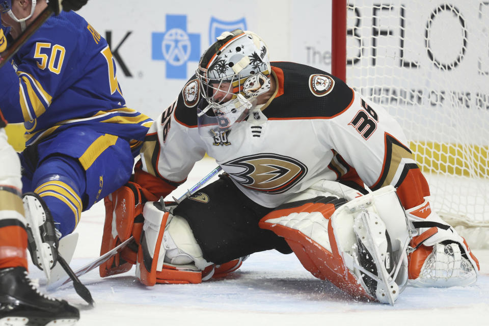 Anaheim Ducks goaltender John Gibson (36) makes a save in front of Buffalo Sabres' Eric Robinson (50) during the first period of an NHL hockey game against the Buffalo Sabres Monday, Feb. 19, 2024, in Buffalo, N.Y. (AP Photo/Jeffrey T. Barnes)
