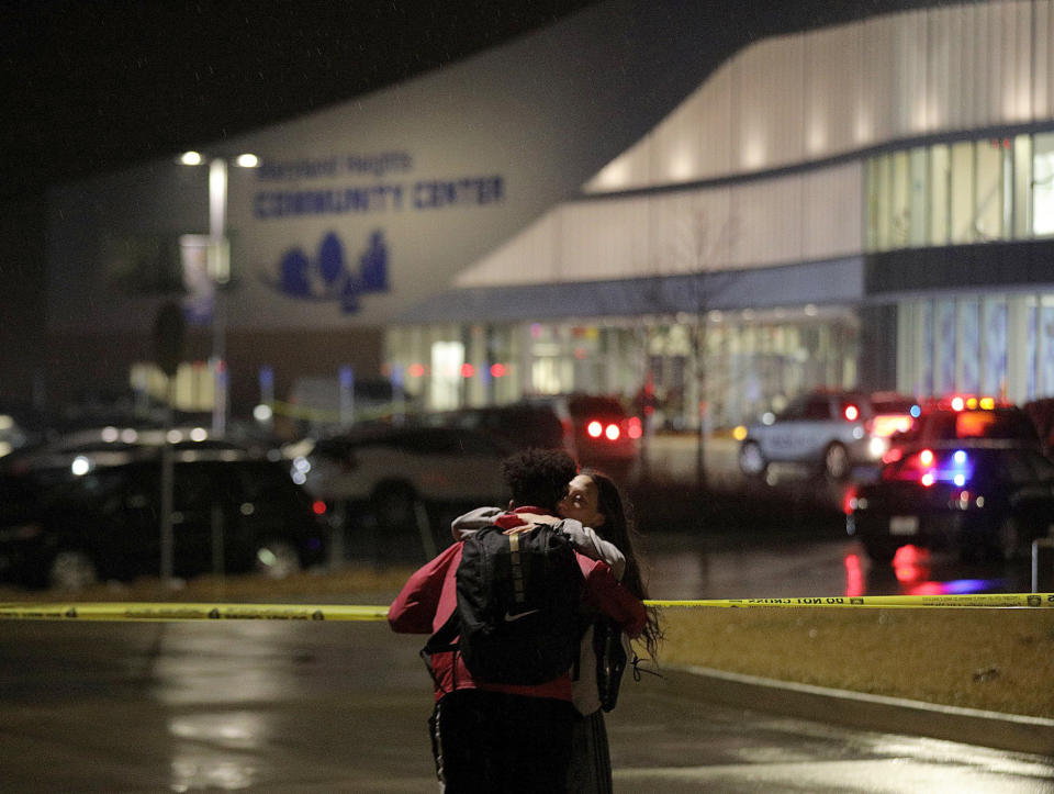 Jaylen Greenlee embraces his friend Becca Johnson outside the Maryland Heights Community Center on Monday, Feb. 24, 2020, after a gunman entered the complex and fired shots, killing at least one. Authorities say a part-time janitor killed a co-worker at the Maryland Heights Community Center in St. Louis before a police officer rushed inside and exchanged gunfire with the shooter. The gunman was seriously wounded. (Christian Gooden/St. Louis Post-Dispatch via AP)