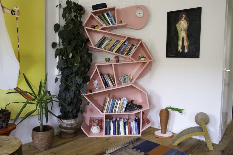 detail of pink zigzag bookshelf in white and yellow living room