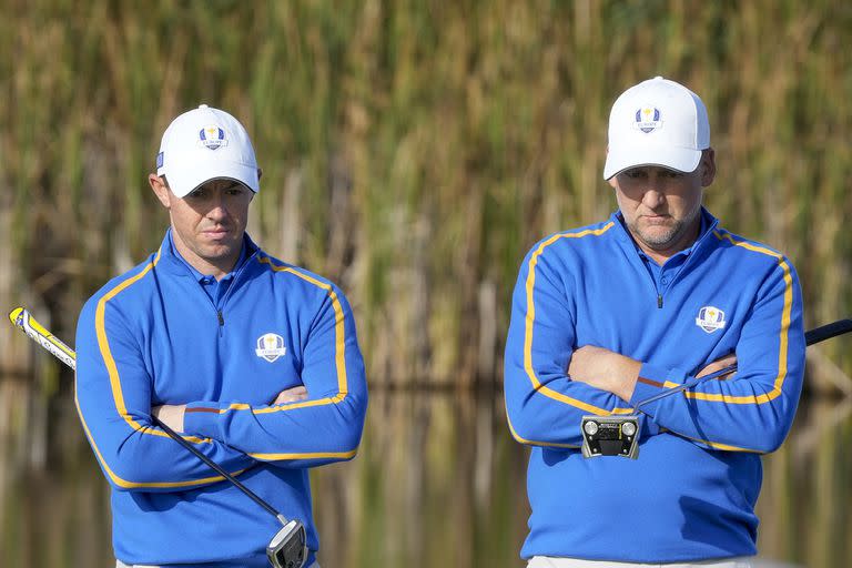 Team Europe's Rory McIlroy and Team Europe's Ian Poulter wait to putt on the fifth hole during a foursome match the Ryder Cup at the Whistling Straits Golf Course Friday, Sept. 24, 2021, in Sheboygan, Wis. (AP Photo/Charlie Neibergall)