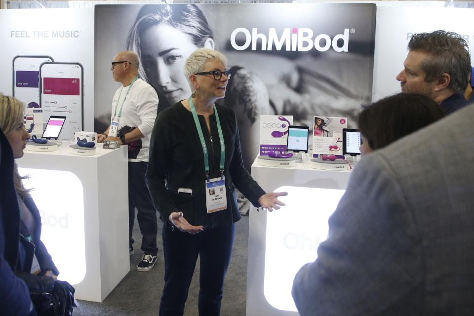 Suki Dunham, co-founder of OhMiBod, talks about her massager devices with app capable music located in the Health & Wellness area during the CES tech show Tuesday, Jan. 7, 2020, in Las Vegas. CES is allowing space for sex tech companies as a one-year trial. At the show, such companies were scattered throughout the health and wellness section, near startups pitching fitness trackers and infrared saunas. (AP Photo/Ross D. Franklin)