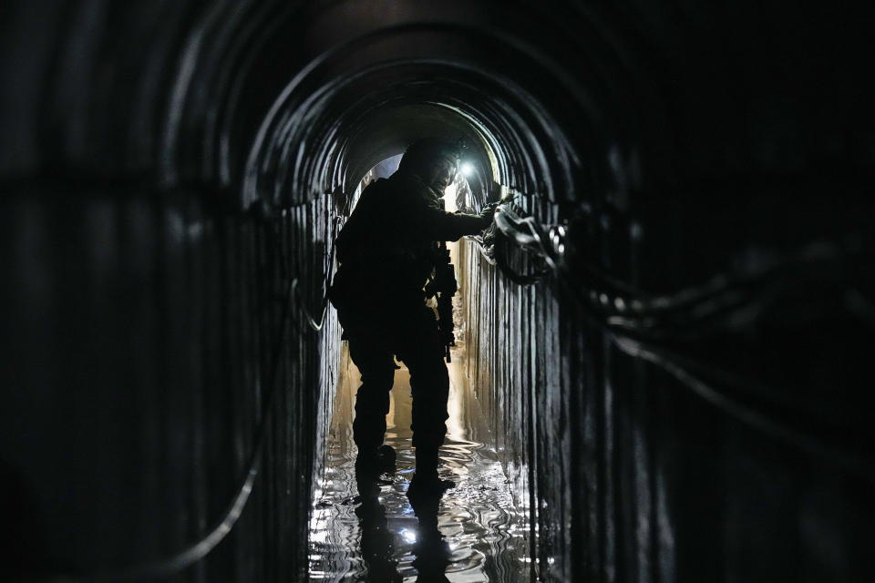 FILE - Lt. Col. Ido, whose last name was redacted by the military, walks inside a tunnel underneath the UNRWA compound, where the military discovered tunnels in the main headquarters of the U.N. agency that the military says Hamas militants used to attack its forces during a ground operation in Gaza, on Feb. 8, 2024. The latest proposal for a cease-fire in Gaza has the support of the United States and most of the international community, but Hamas has not fully embraced it, and neither, it seems, has Israel. (AP Photo/Ariel Schalit, File)