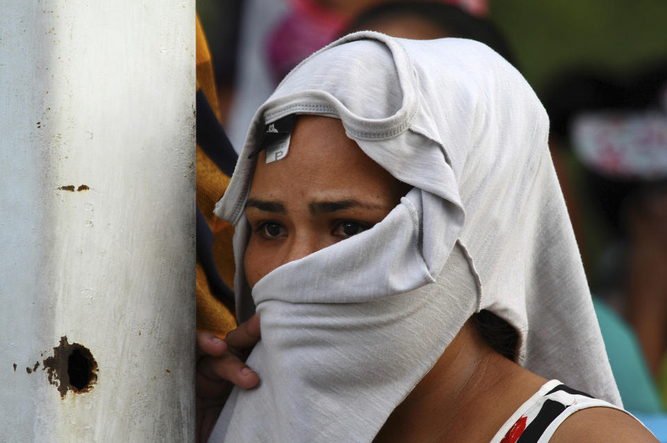 The wife of an inmate waits for information about her husband, outside the Anisio Jobim Prison Complex in Manaus, Amazonas state, Brazil, Monday, May 27, 2019. Brazilian authorities said 42 inmates were killed at three different prisons in the capital of the northern state of Amazonas, a day after 15 prisoners died in a riot at a fourth prison in the city. (AP Photo/Edmar Barros)