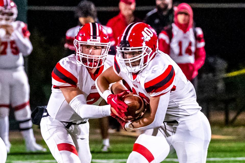 Old Rochester's Noah Sommers fakes the hand off to Jacksen Martin.