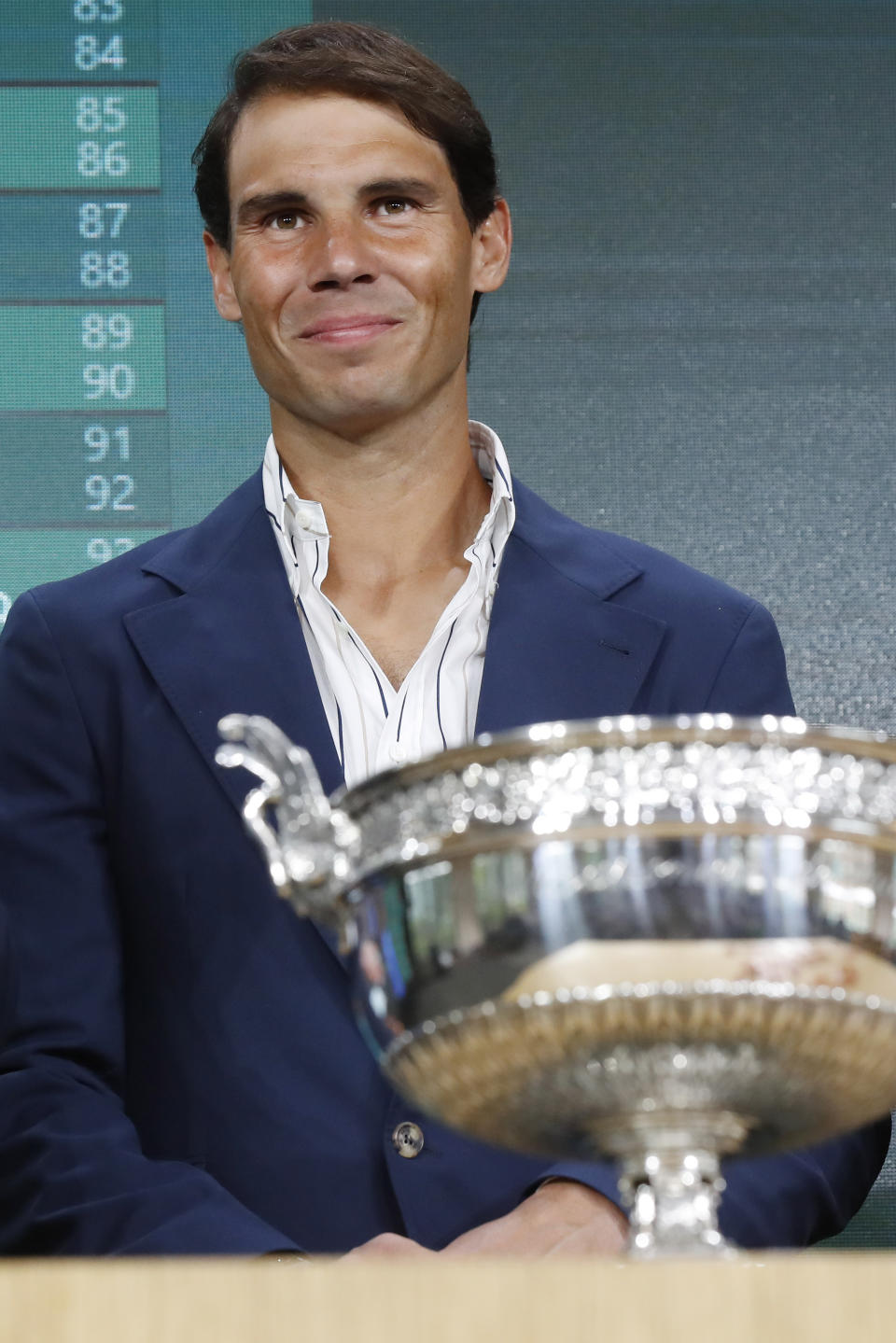 Defending champion Spain's Rafael Nadal poses next to the cup during the draw of the French Open tennis tournament at the Roland Garros stadium in Paris, Thursday, May 23, 2019. The French Open tennis tournament starts Sunday May 26. (AP Photo/Michel Euler)