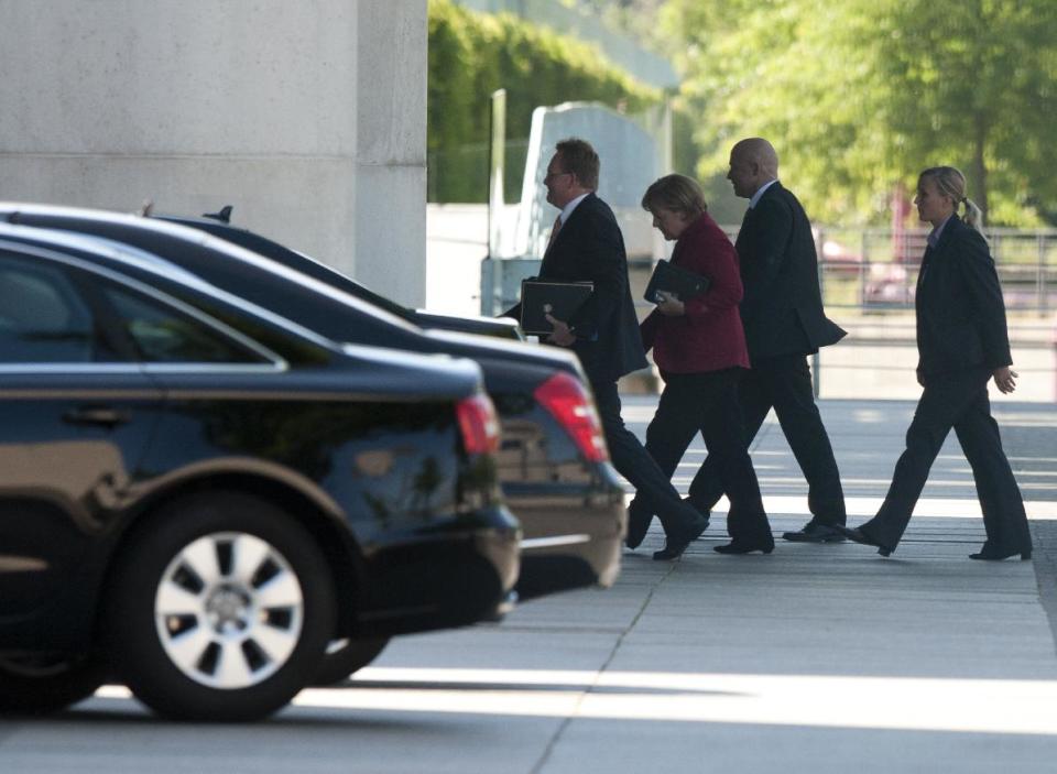 German chancellor Angela Merkel, second left, arrives at the chancellery for a meeting with opposition party leaders in Berlin, Thursday May 24, 2012. Germany's opposition leader says Chancellor Angela Merkel has accepted the need to add a separate set of measures promoting growth to the European Union's treaty enshrining fiscal discipline. Merkel and top lawmakers held a meeting Thursday. Sigmar Gabriel told reporters that she and the government "have moved to accept a pact for growth and investment." Merkel's center-right government needs the support of opposition parties to secure a two-thirds majority in Parliament for the legislation to pass. (AP Photo/dapd/Andreas Prost)