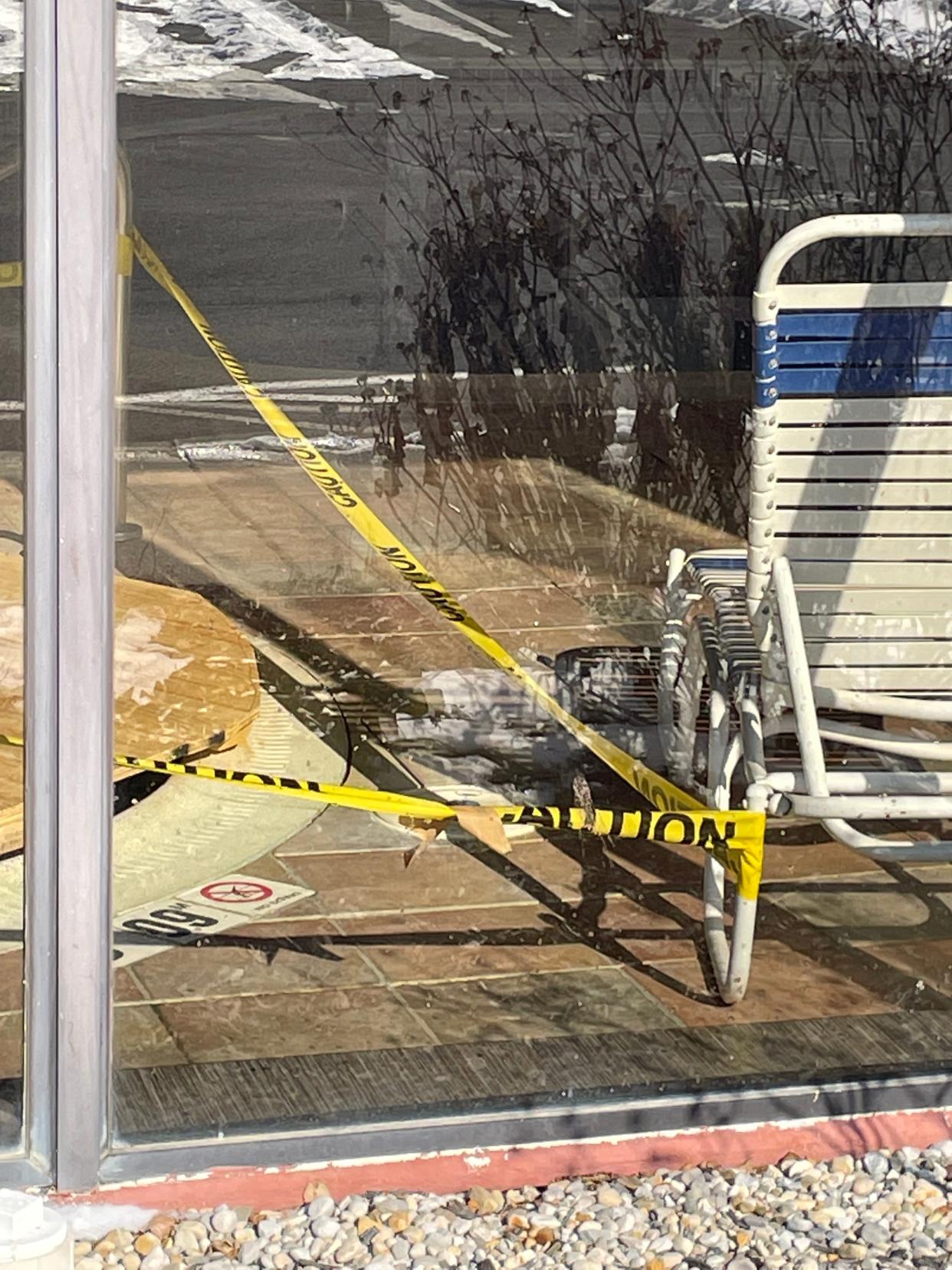 Caution tape lined the pool area Sunday morning at the Hampton Inn in Marysville. The source of a carbon monoxide leak at the hotel Saturday may have came from a pool heater.