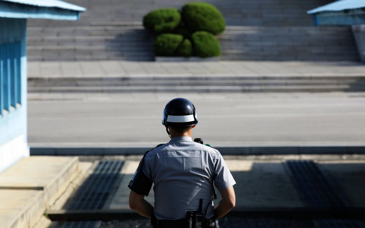 A South Korean soldier stands guard at the Demilitarized Zone (DMZ) in the border village of Panmunjom, South Korea - GETTY IMAGES ASIAPAC / POOL