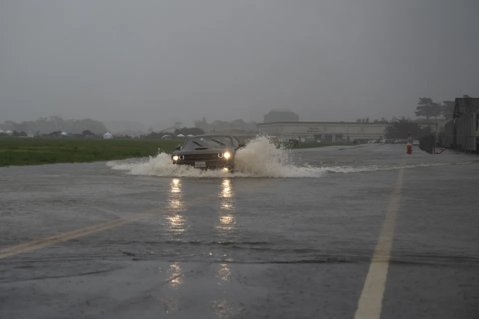 Cars drive through a flooded road in San Francisco on Dec 31, 2022. (Mike Kai Chen/The New York Times)