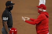 Los Angeles Angels manager Joe Maddon, right, argues with third base umpire Edwin Moscoso (109) in the second inning of a baseball game against the Texas Rangers in Arlington, Texas, Friday, Aug. 7, 2020. (AP Photo/Tony Gutierrez)