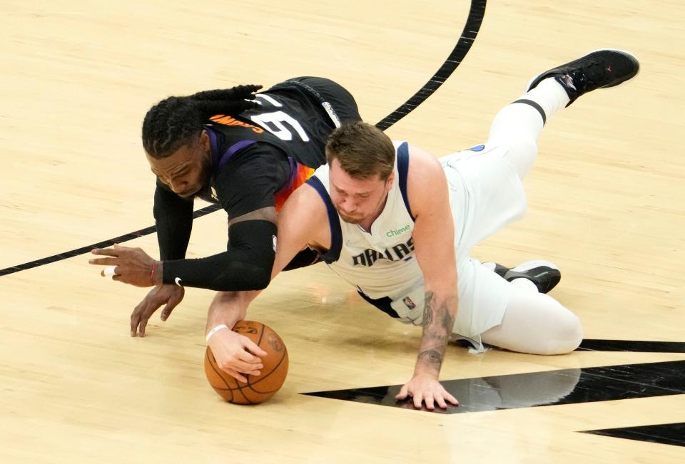 May 10, 2022; Phoenix, Arizona, USA; Phoenix Suns forward Jae Crowder (99) battles for the ball with Dallas Mavericks guard Luka Doncic (77) during game five of the second round for the 2022 NBA playoffs at Footprint Center.