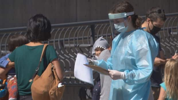 The pop-up COVID-19 assessment centre at the McNabb Arena opened 30 minutes ahead of schedule on Saturday to help accommodate the growing line of people.  (Alex Behne/CBC - image credit)