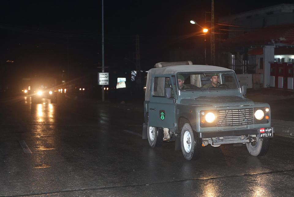 Lebanese army soldiers lead an official security convoy carrying a group of released Greek Orthodox nuns as they make their way to Syria, at the Lebanese border crossing point of Masnaa, eastern Bekaa valley, Lebanon, early Monday March 10, 2014. Syrian rebels released about a dozen Greek Orthodox nuns who have been held since December, Lebanon's official news agency reported Monday. The release of the nuns and their helpers, 16 women in all, is a rare successful prisoner-exchange deal between Syrian government authorities and the rebels seeking to overthrow the rule of President Bashar Assad. (AP Photo/Hussein Malla)