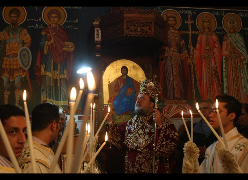 A Greek Orthodox priest celebrates Christmas mass at a church in Gaza city on January 7, 2011, as Orthodox Christians use the old Julian calendar in which Christmas falls 13 days after the date in the more widespread Gregorian calendar.&nbsp;