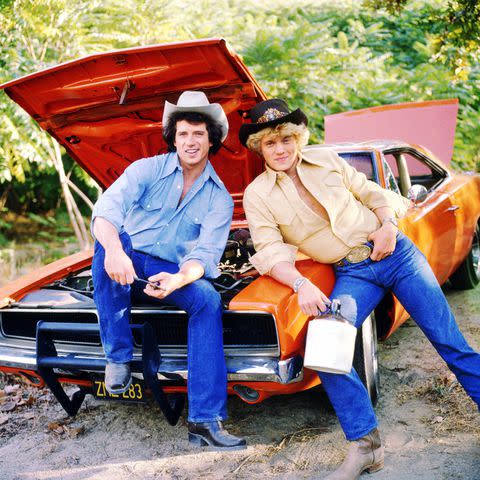 <p>CBS via Getty</p> Tom Wopat (left) as Luke Duke and John Schneider as Bo Duke in the CBS television series "The Dukes of Hazzard"