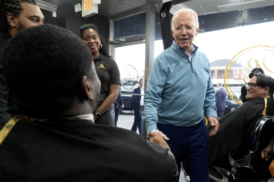 President Joe Biden, standing at right, greets patrons at the Regal Lounge barber shop and spa in Columbia, S.C., Saturday, Jan. 27, 2024. (AP Photo/Jacquelyn Martin)