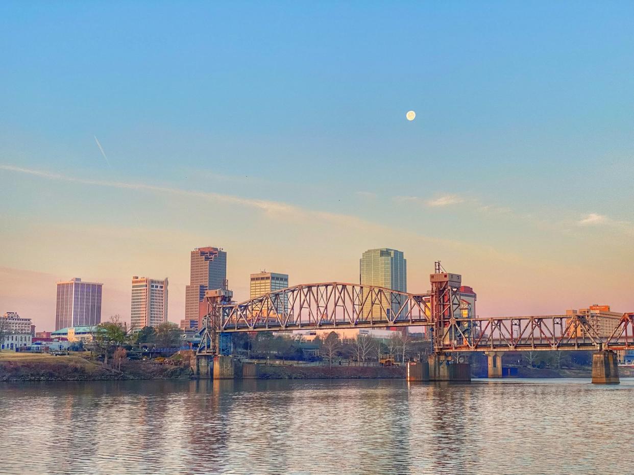 The sunrise collides with the moon  over the Little Rock, Arkansas skyline on the first day of spring.