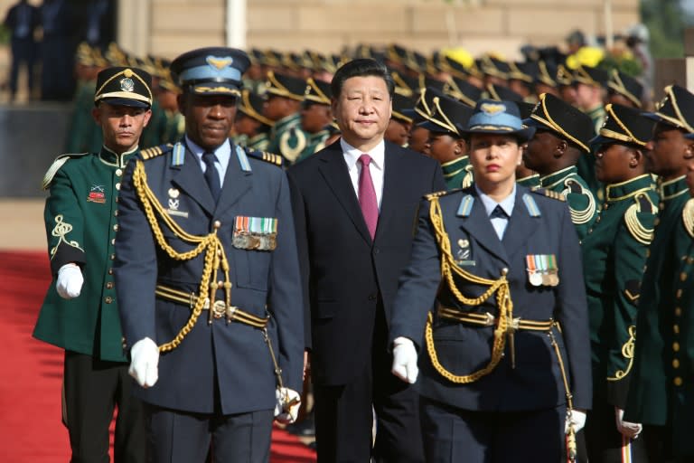 Chinese President Xi Jinping (C) walks past the guard of honour at the Union Buildings in Pretoria, during the start of his official tour to South Africa on December 2, 2015 African leaders and Chinese President Xi Jinping will hold two days of talks in Johannesburg as the continent seeks to secure further massive investment despite China's economic slowdown