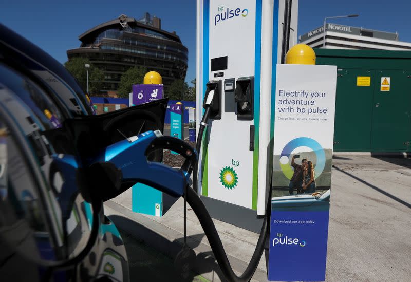 An electric powered taxi is seen being charged at a BP Pulse electric vehicle charging point in London