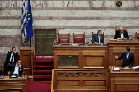 Greek conservative New Democracy party leader Kyriakos Mitsotakis addresses to Greek Prime Minister Alexis Tsipras (L) during a parliamentary session before a vote on setting up a special committee which will probe the role of ten politicians in a case which involves alleged bribery by Swiss drugmaker Novartis, in Athens, Greece, February 21, 2018. REUTERS/Alkis Konstantinidis