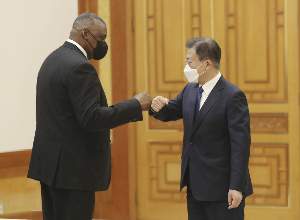South Korean President Moon Jae-in, right, bumps elbows with U.S. Defense Secretary Lloyd Austin before their meeting at the presidential Blue House in Seoul, South Korea, Thursday, Dec. 2, 2021. Austin said Thursday that China's pursuit of hypersonic weapons "increases tensions in the region" and vowed the U.S. would maintain its capability to deter potential threats posed by China. (Ahn Jung-hwan/Yonhap via AP)
