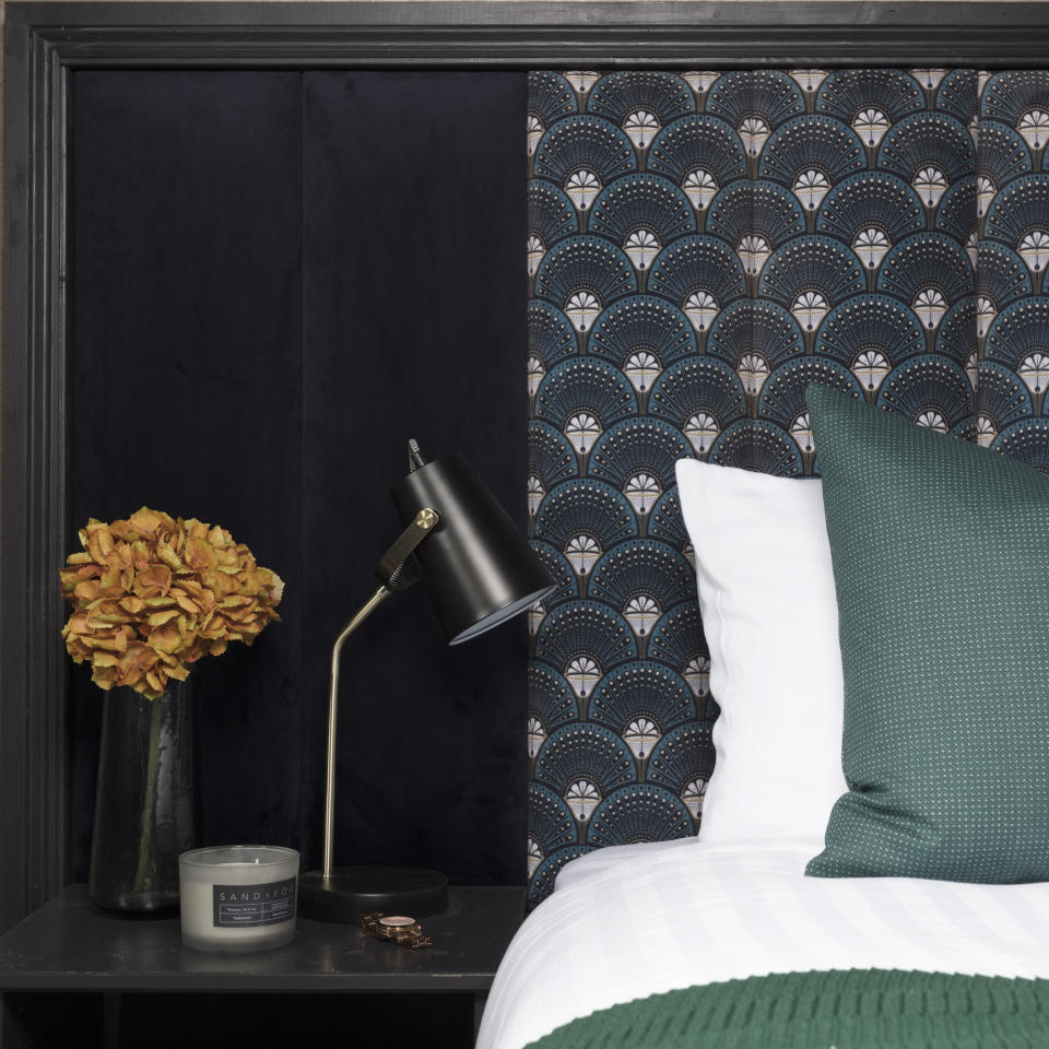 black bedroom with upholstered headboard