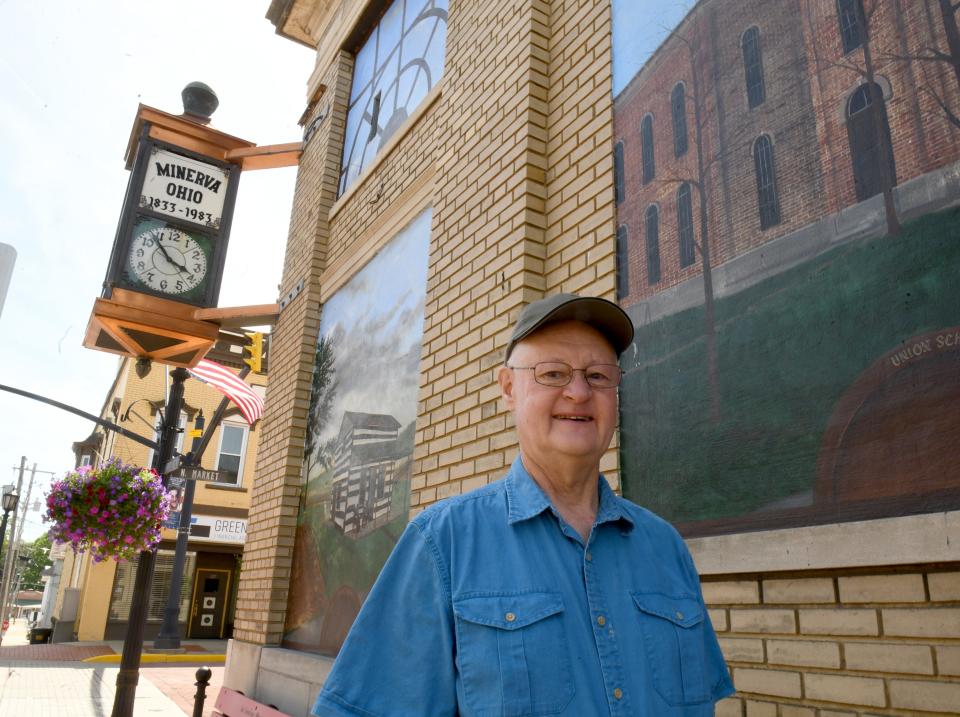 Chip Syme, president of Minerva Area Historical Society, stands Thursday, June 9, 2022, near the historic clock tower that his organization is seeking to restore.