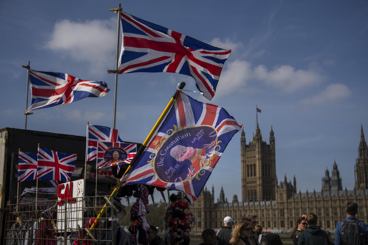 Flags commemorating the coronation of King Charles III are displayed for sale at a street stand, outside Westminster Hall in London, Wednesday, May 3, 2023. The Coronation of King Charles III will take place at Westminster Abbey on May 6. (AP Photo/Emilio Morenatti)